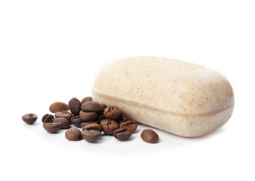 Soap bar and coffee beans on white background