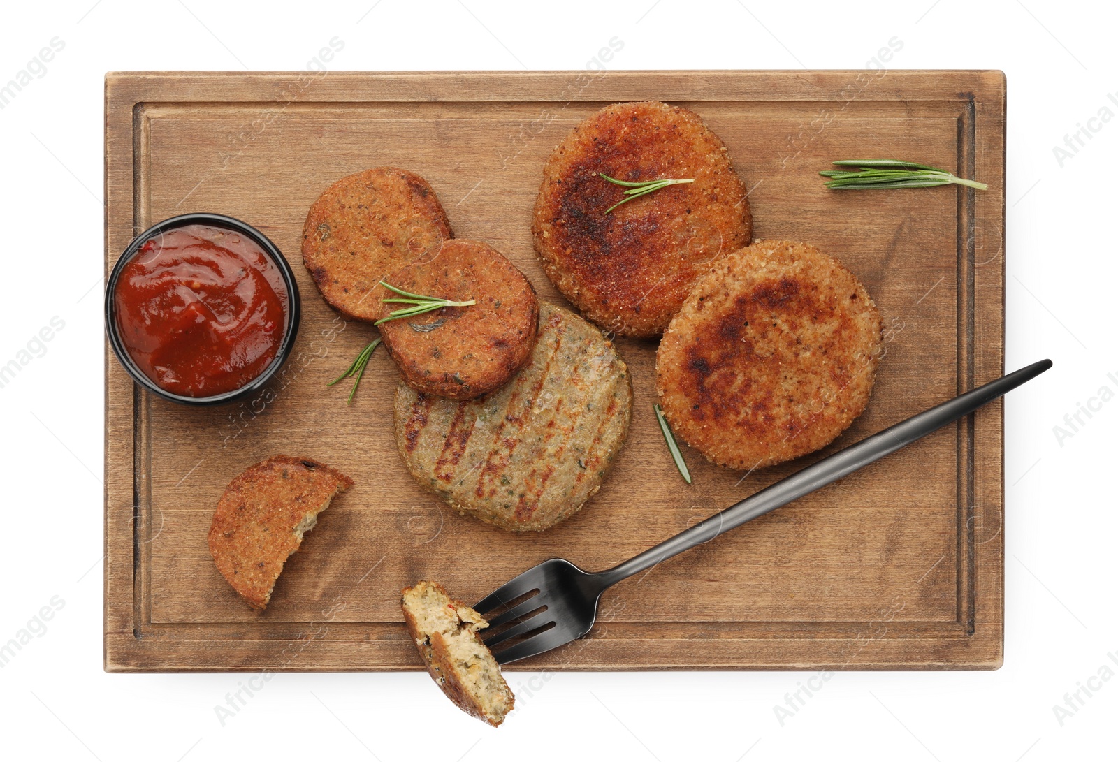 Photo of Serving board with vegan cutlets, fork and ketchup isolated on white, top view