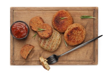 Photo of Serving board with vegan cutlets, fork and ketchup isolated on white, top view