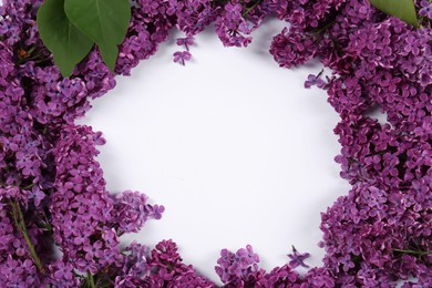 Photo of Frame made of beautiful lilac flowers on white background, above view. Space for text