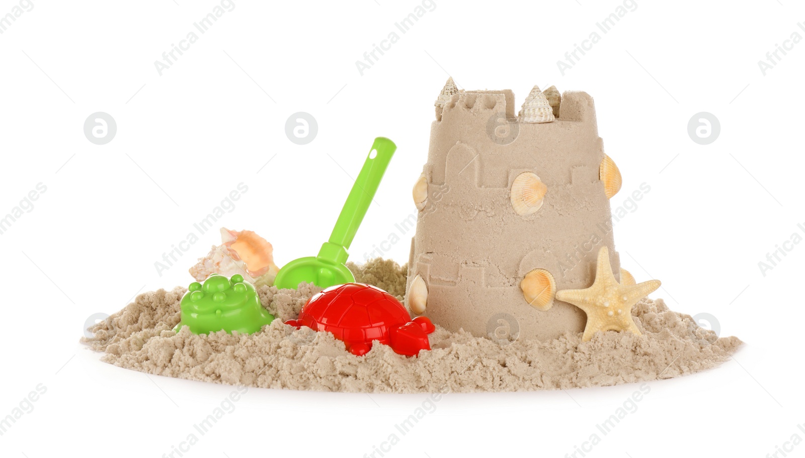 Photo of Plastic beach toys and figure on pile of sand against white background. Outdoor play