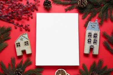 Blank canvas and Christmas decor on red background, flat lay. Space for design