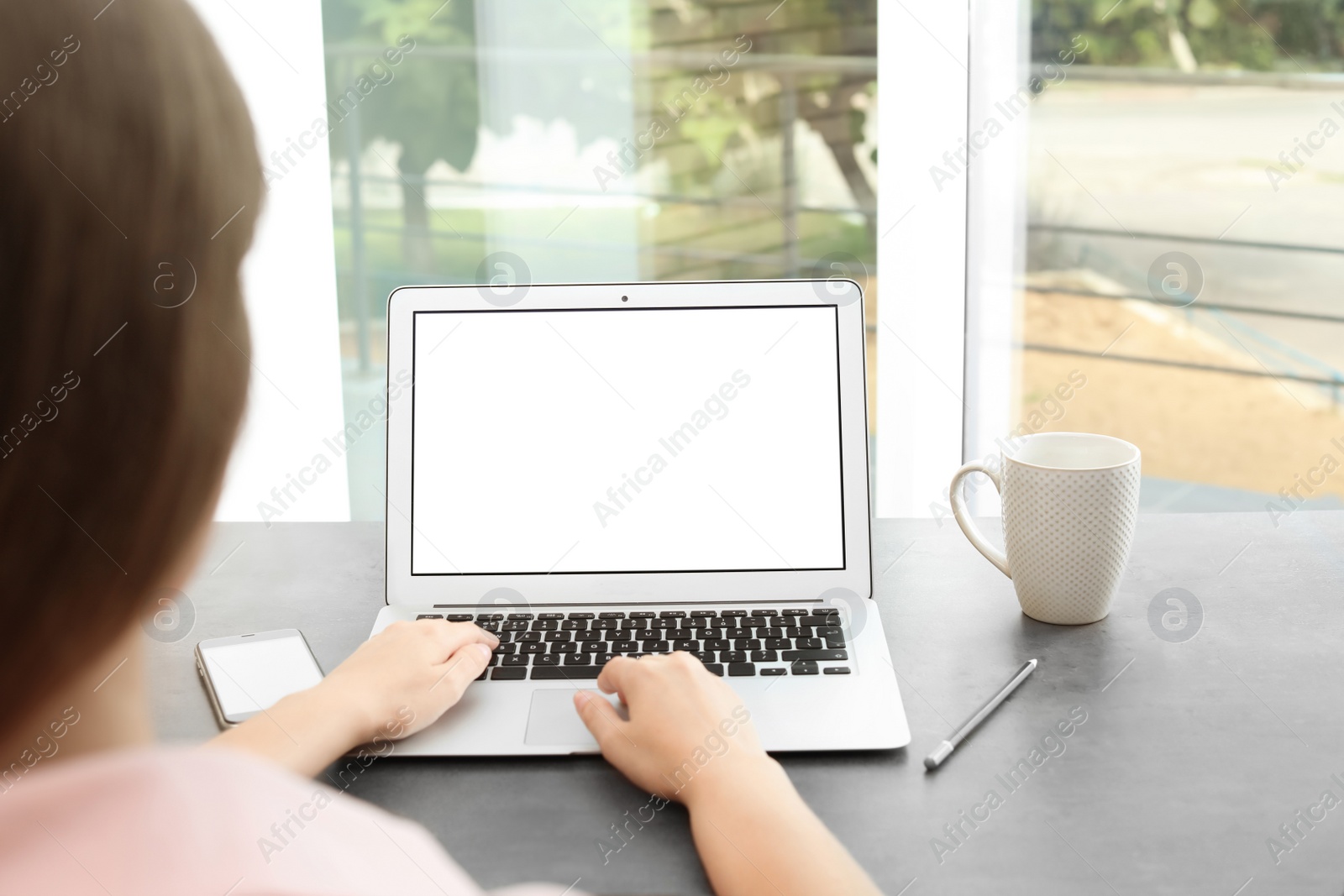 Photo of Woman working with laptop at home. Mock up with space for text