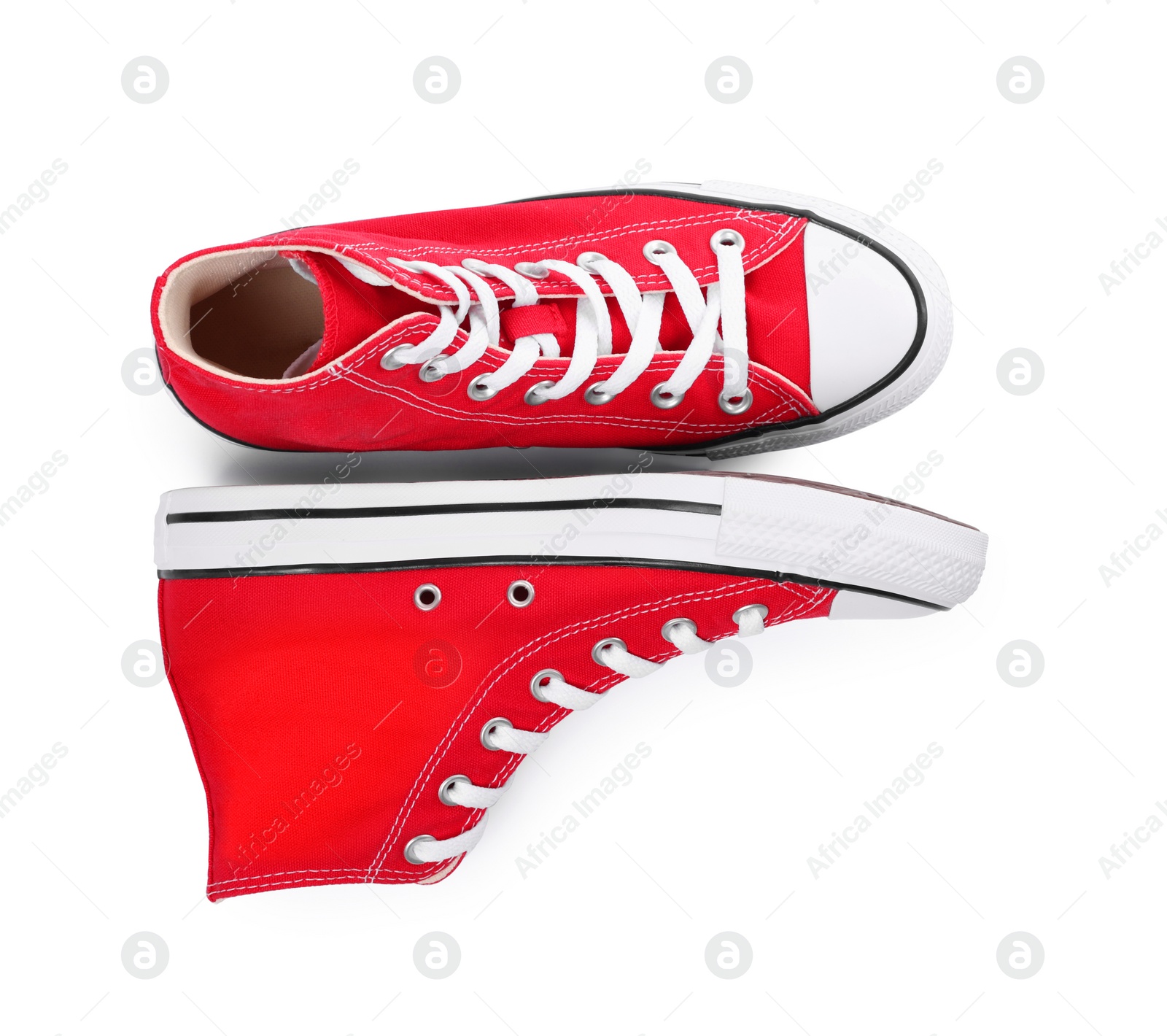 Photo of Pair of new red stylish plimsolls on white background, top view