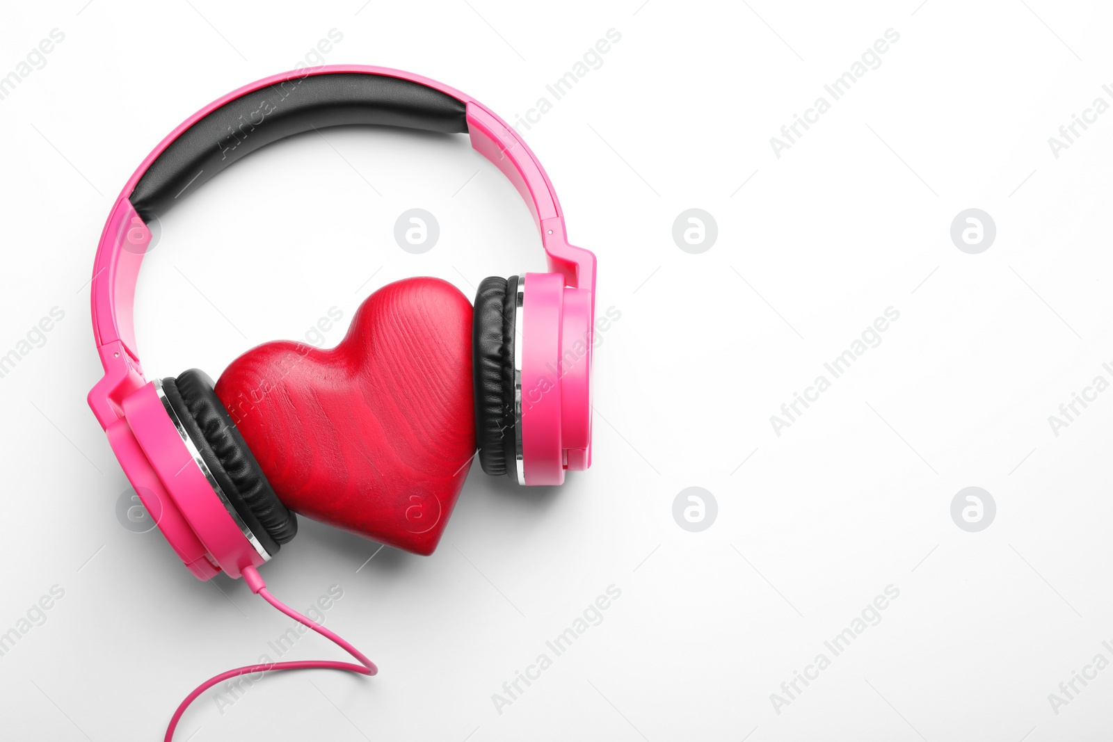 Photo of Decorative heart and modern headphones on white background, top view