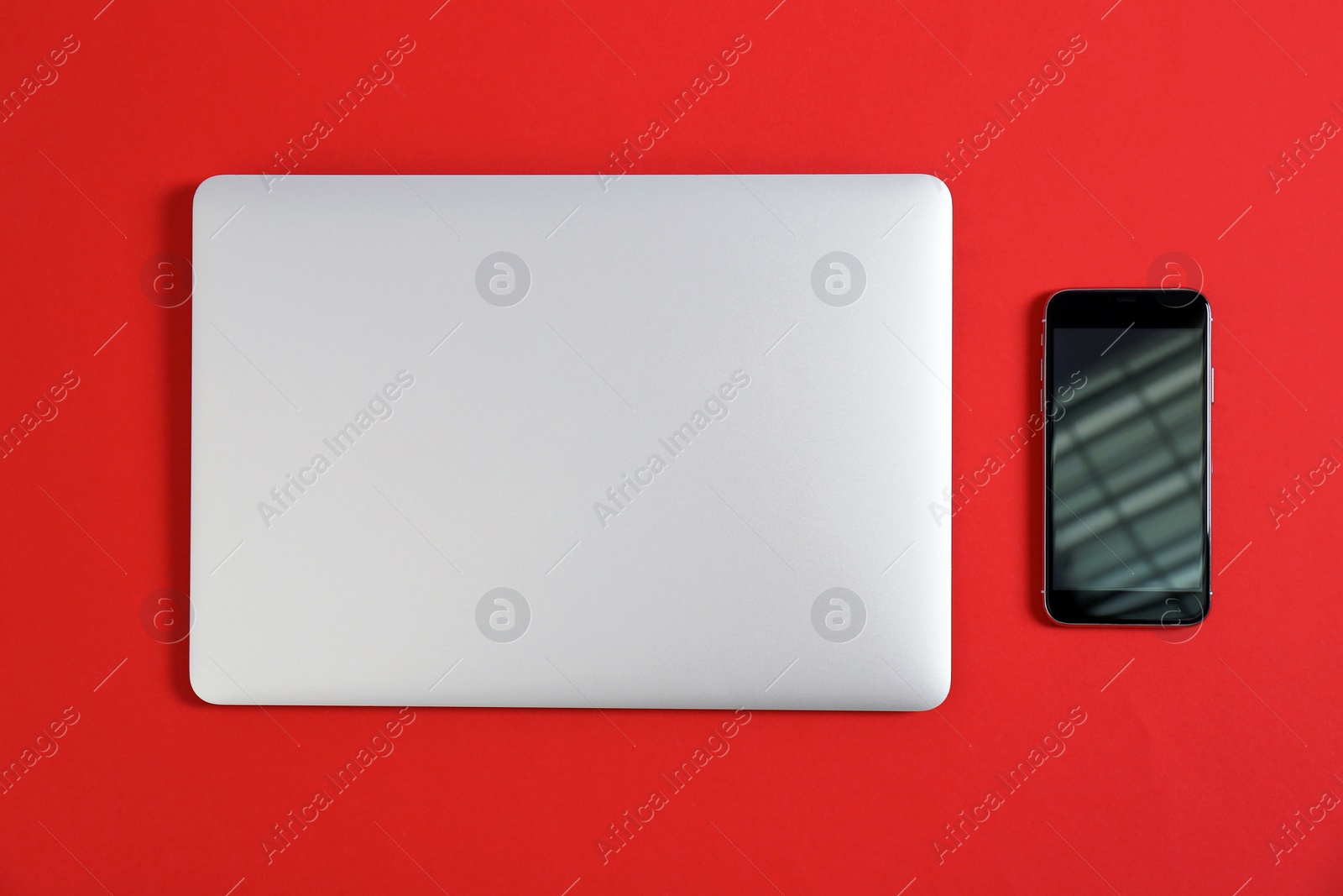 Photo of Modern laptop and mobile phone on color background, top view