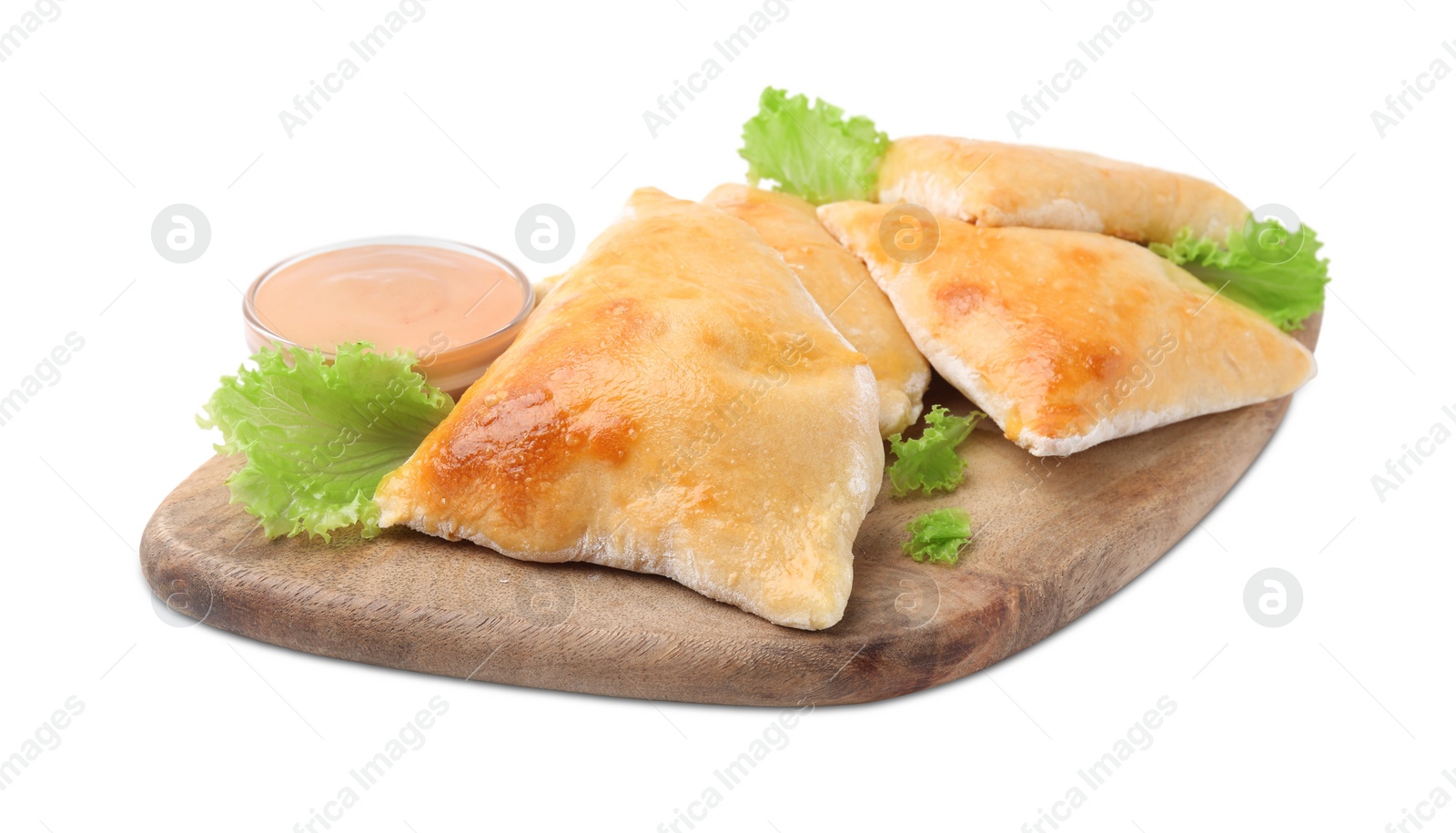 Photo of Wooden board with delicious samosas, lettuce and sauce isolated on white