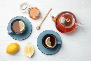 Photo of Flat lay composition with black tea on wooden table