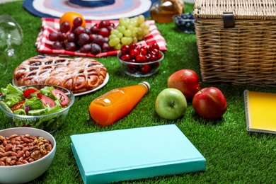 Photo of Many different products on green grass. Summer picnic