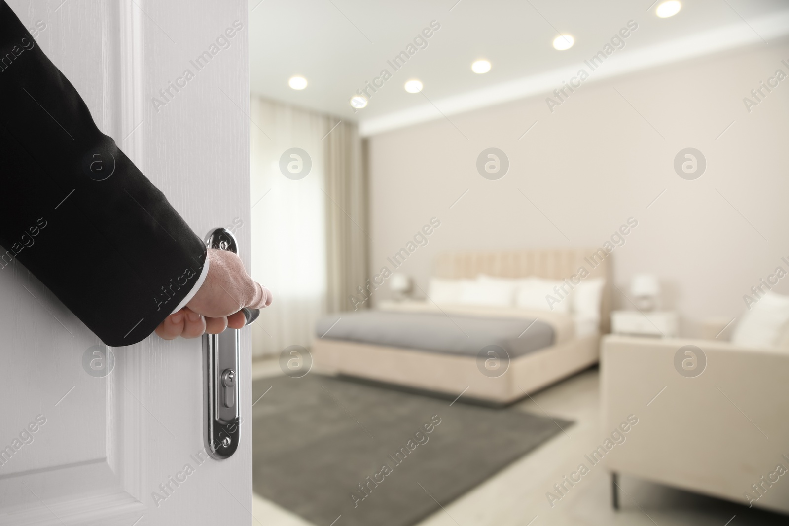 Image of Man opening wooden door to hotel room, closeup