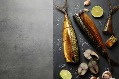 Photo of Tasty smoked fish on grey table, top view. Space for text