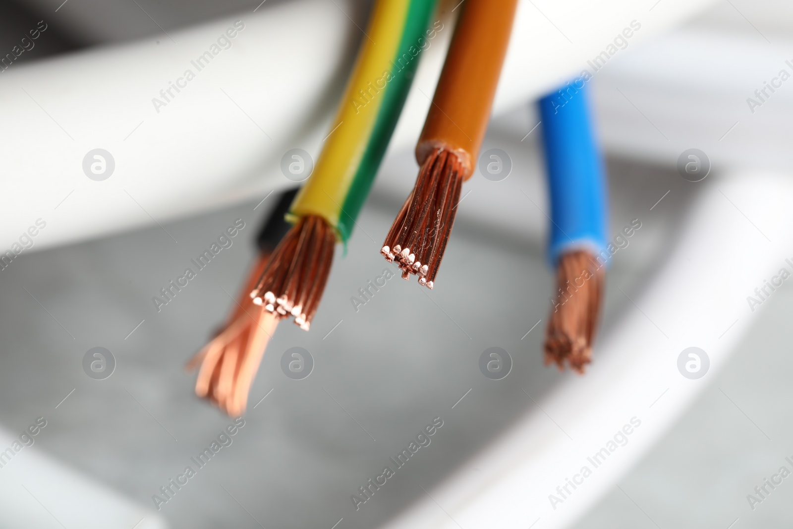 Photo of Colorful electrical wires on blurred background, closeup