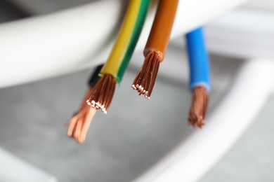 Colorful electrical wires on blurred background, closeup