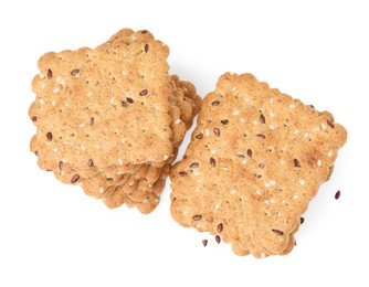 Photo of Stacks of cereal crackers with flax and sesame seeds isolated on white, top view