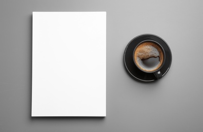 Blank paper sheets for brochure and cup of coffee on grey background, flat lay. Mock up