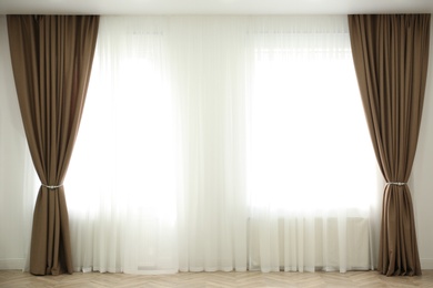 Photo of Windows with elegant curtains in modern room