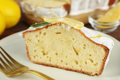 Photo of Piece of tasty lemon cake with glaze served on table, closeup