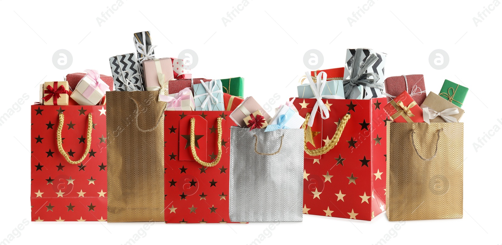 Image of Set of paper shopping bags with gifts on white background