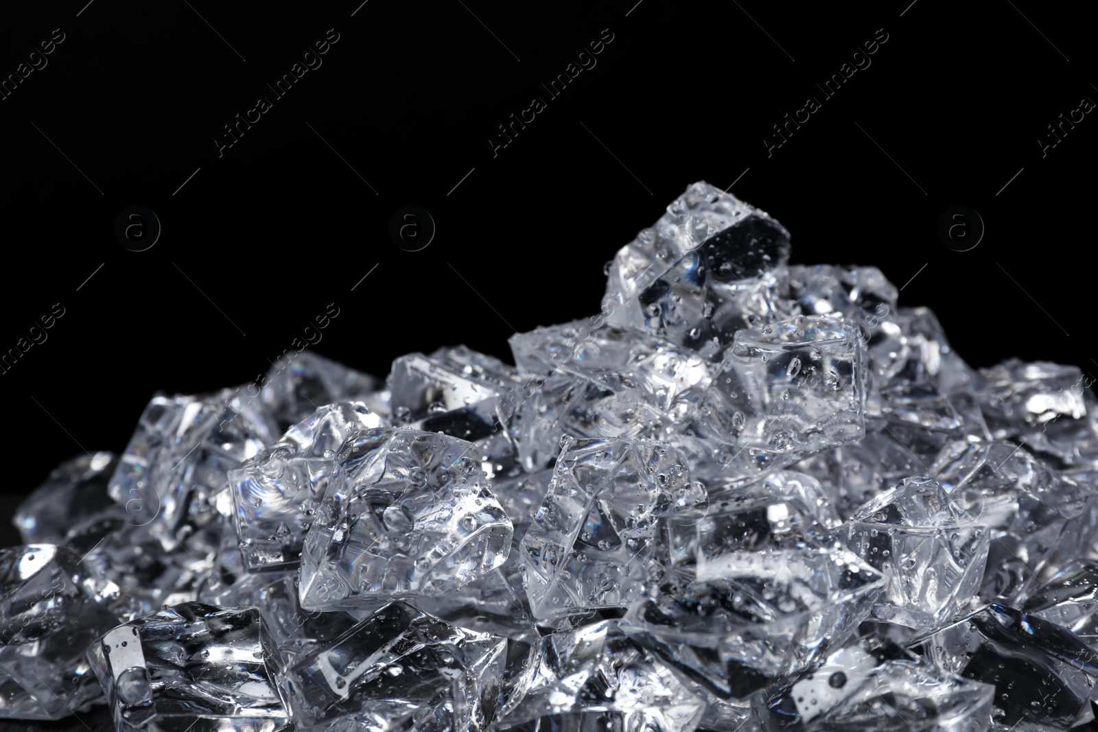 Photo of Pile of crushed ice on black background, closeup