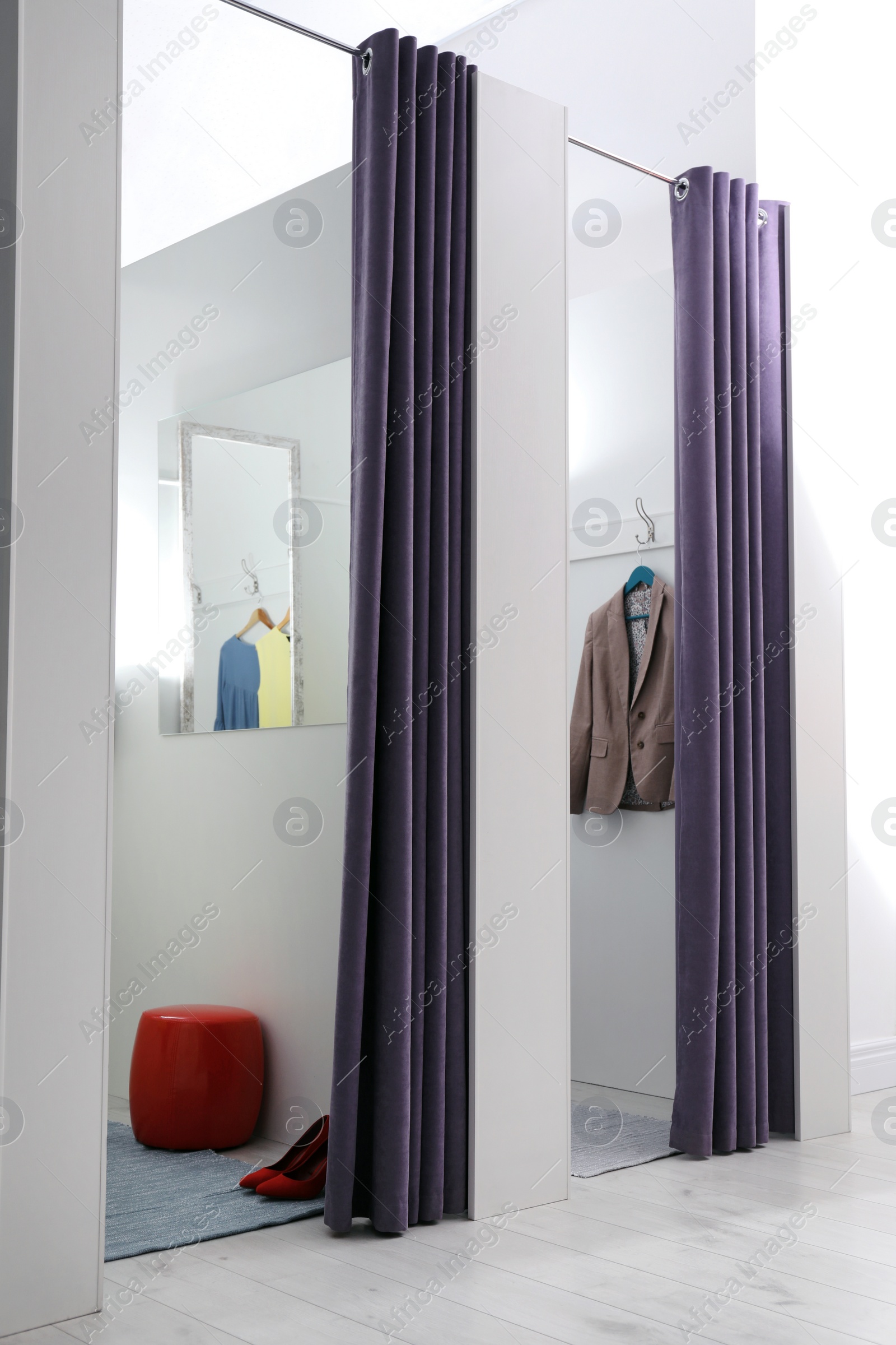 Photo of Empty dressing rooms in fashion store. Stylish interior