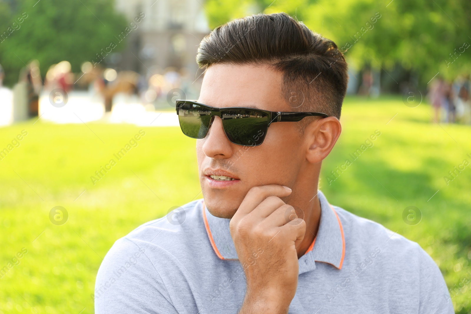 Photo of Handsome man wearing stylish sunglasses in park