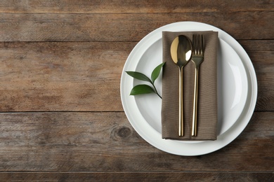 Beautiful table setting on wooden background, flat lay. Space for text