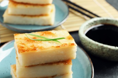 Photo of Delicious turnip cake with herb on plate, closeup