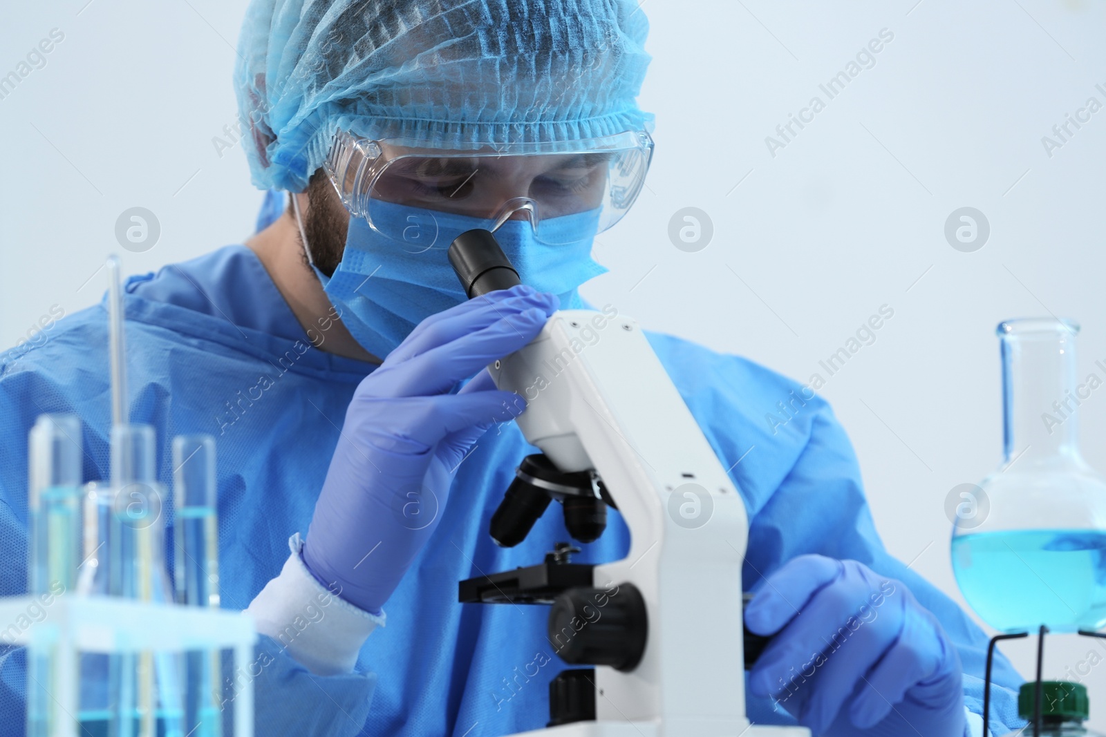 Photo of Scientist working with microscope in laboratory. Medical research