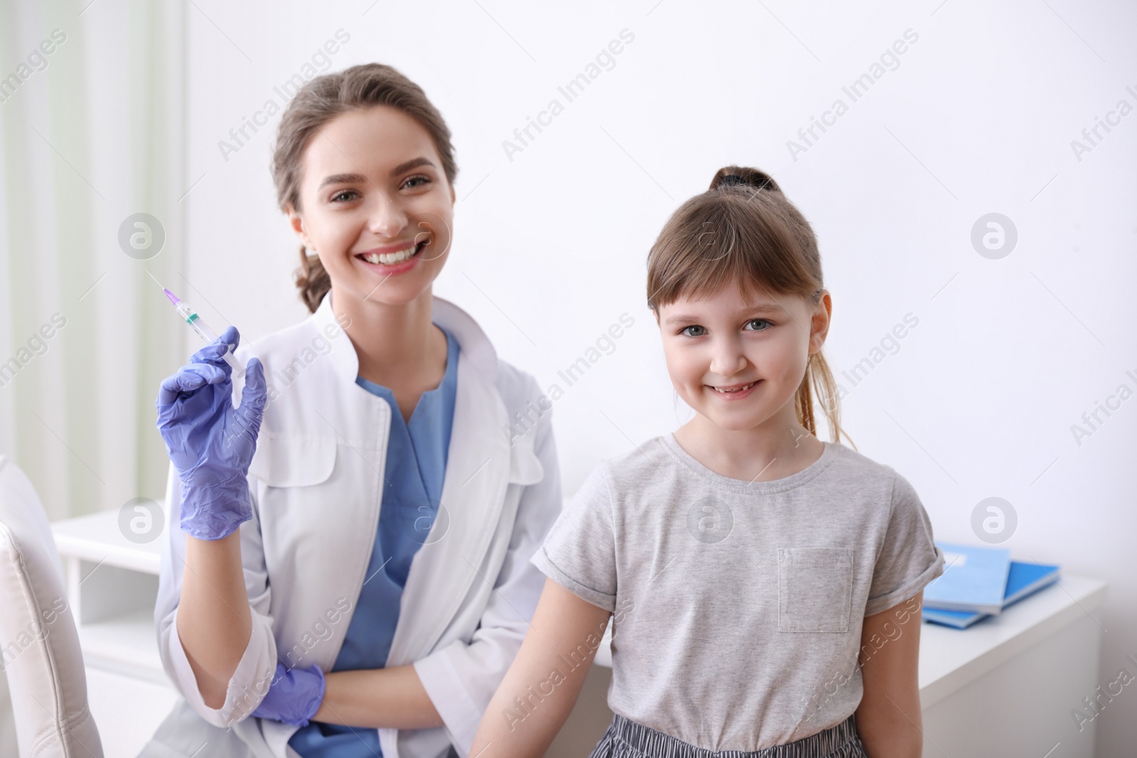 Photo of Little girl receiving chickenpox vaccination in clinic. Varicella virus prevention