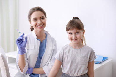 Photo of Little girl receiving chickenpox vaccination in clinic. Varicella virus prevention