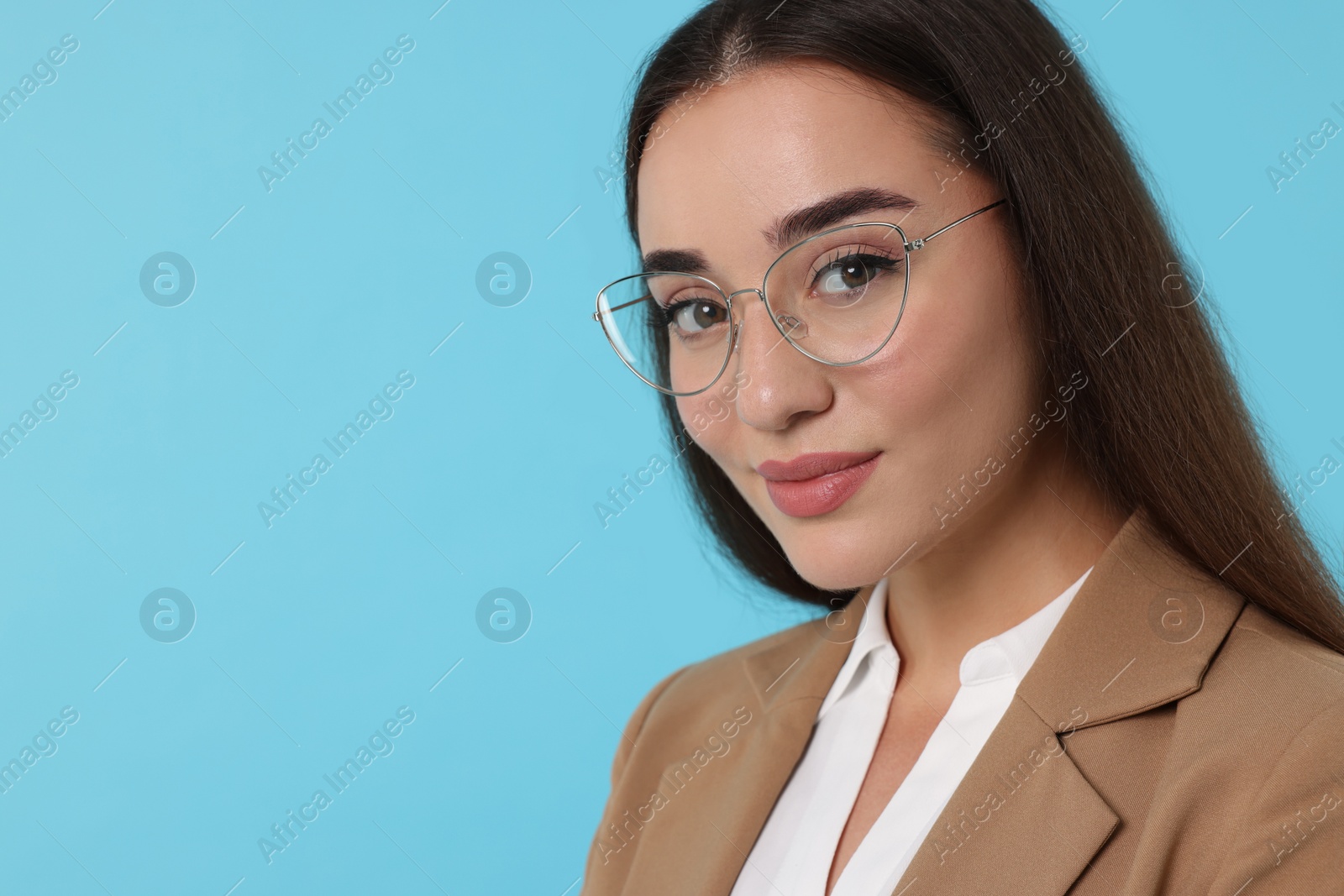 Photo of Beautiful woman wearing glasses on turquoise background. Space for text