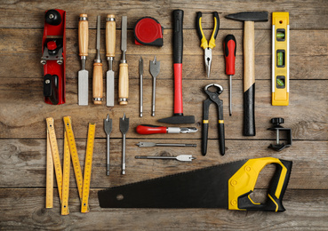 Flat lay composition with carpenter's tools on wooden background