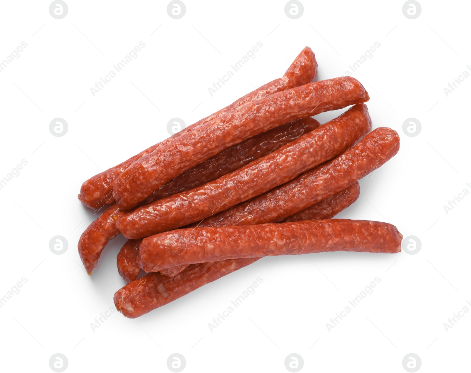 Photo of Many thin dry smoked sausages isolated on white, top view