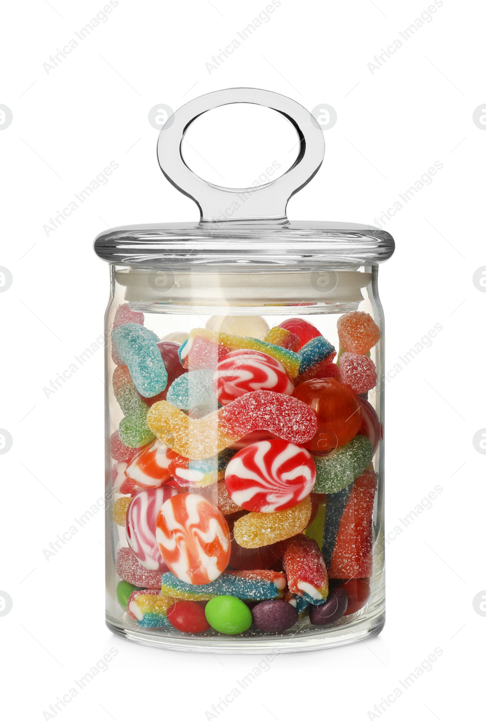 Photo of Many different candies in glass jar isolated on white