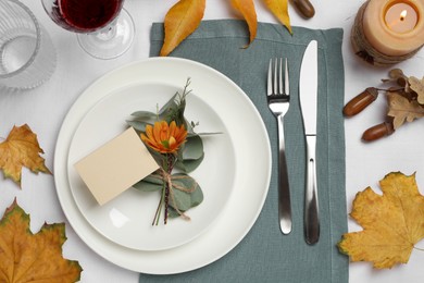 Photo of Beautiful autumn place setting with blank card and decor on table, flat lay