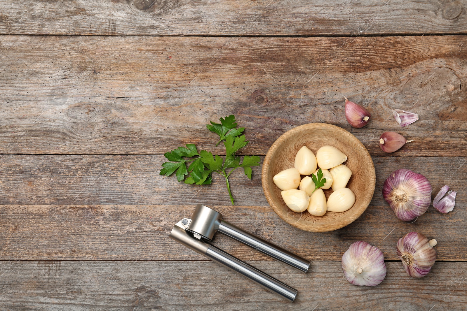 Photo of Flat lay composition with garlic press on wooden table