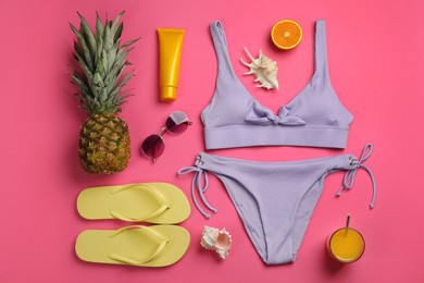 Photo of Flat lay composition with beach objects on pink background