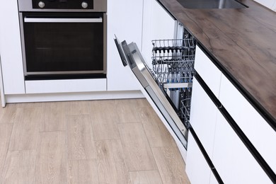 Built-in dishwasher with open door in kitchen