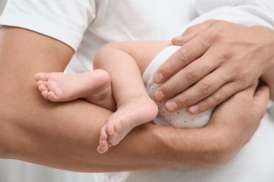 Photo of Father holding his cute baby, closeup view