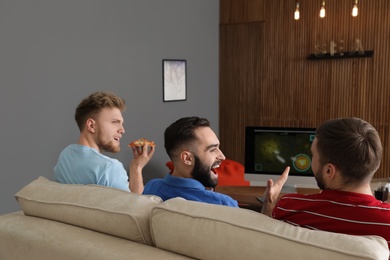 Photo of Group of friends playing video games at home
