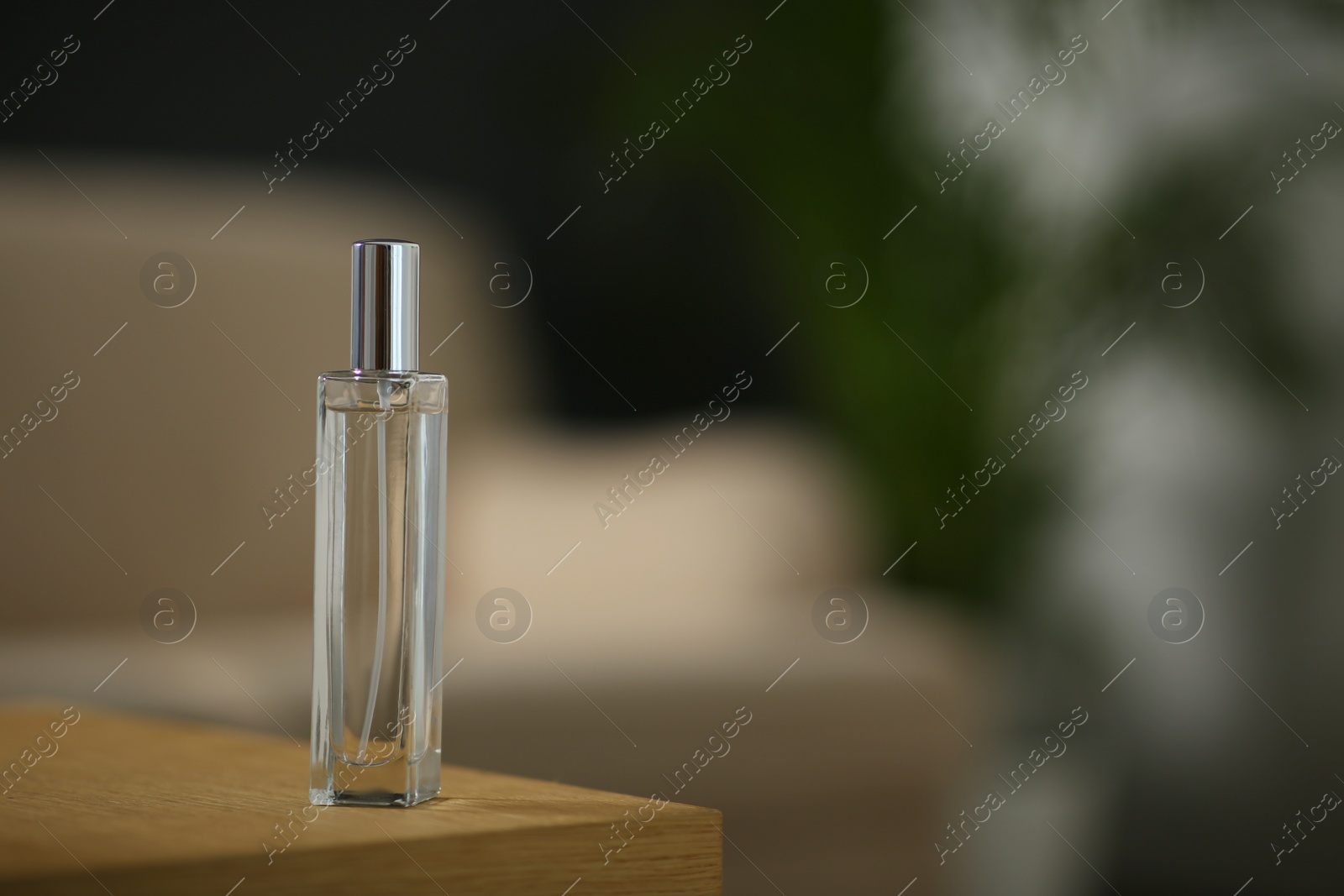 Photo of Air freshener on wooden table indoors. Space for text