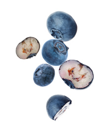 Image of Many fresh ripe blueberries falling on white background