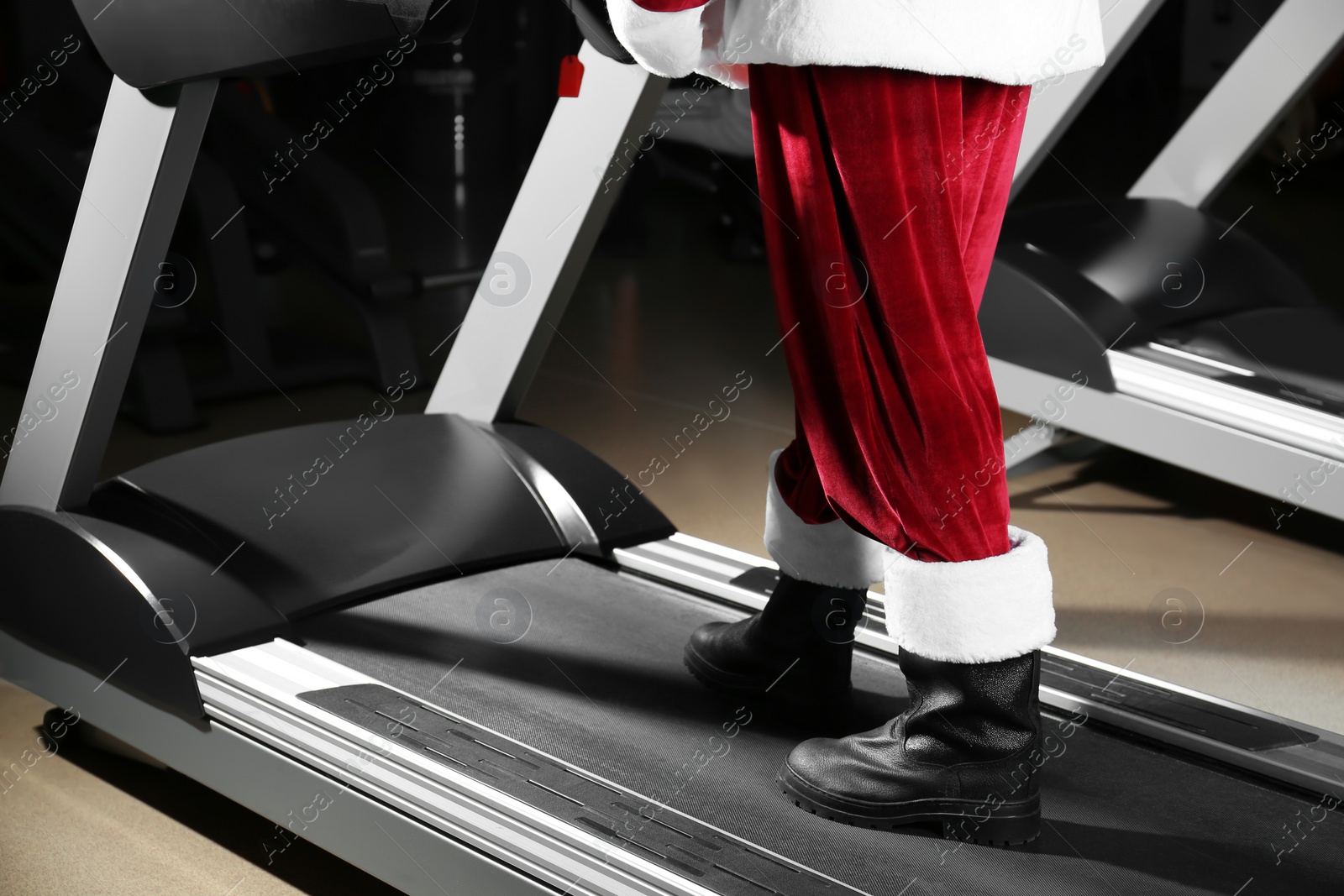 Photo of Authentic Santa Claus training on treadmill in modern gym, closeup