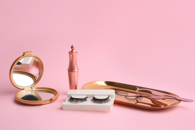 Photo of Magnetic eyelashes and accessories on pink background