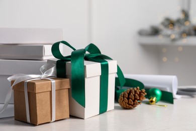 Beautiful gift boxes and Christmas decorations on white table