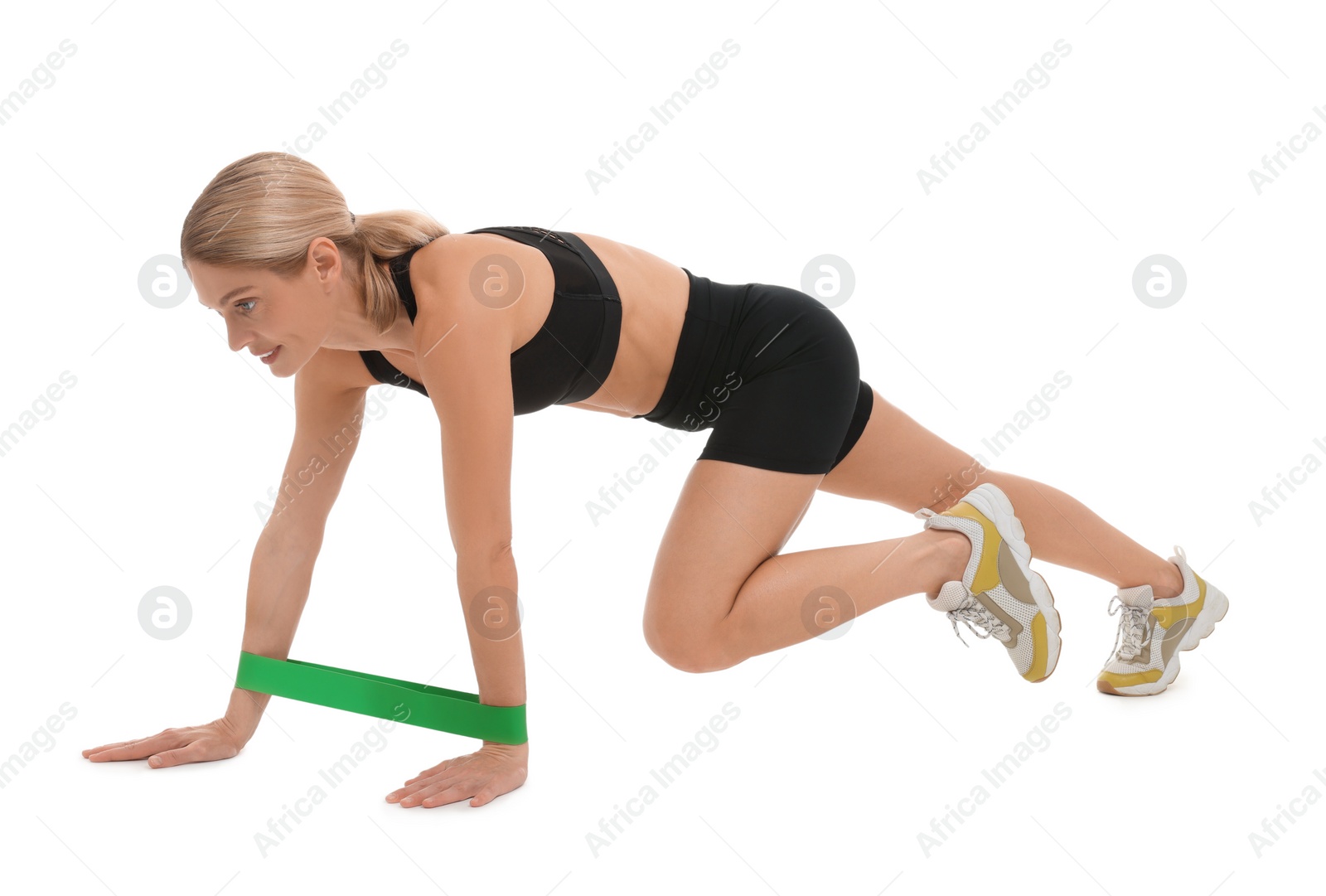 Photo of Woman exercising with elastic resistance band on white background