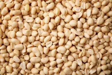 Photo of Dry shelled peanuts as background, top view. Healthy snack