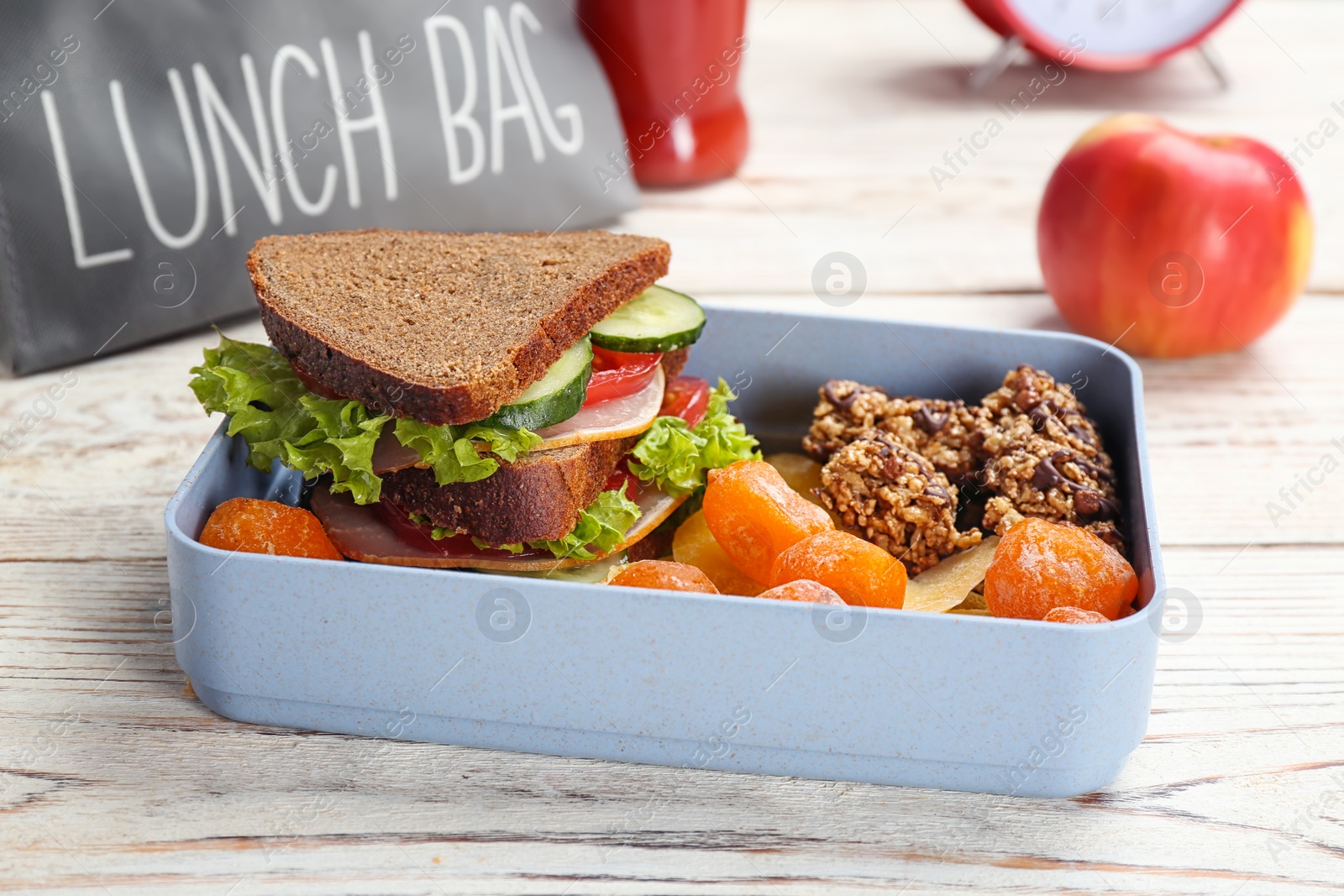 Photo of Lunch box with appetizing food on wooden table