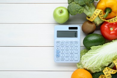 Photo of Calculator and food products on white wooden table, flat lay with space for text. Weight loss concept