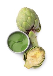 Photo of Package of under eye patches and artichokes on white background, top view. Cosmetic product